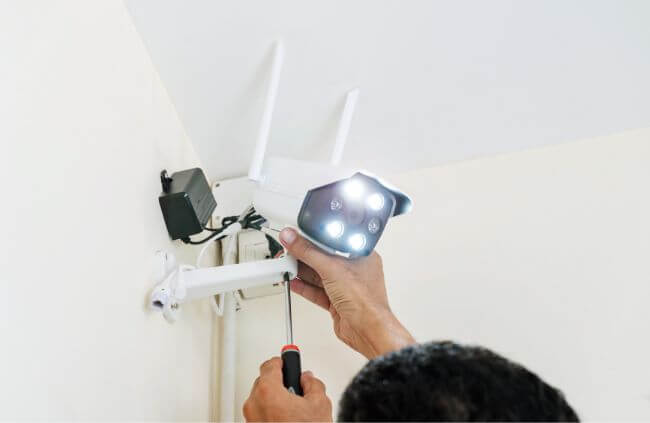 Home security camera system repairs by Home Security Guys, showing close-up of wireless unit maintenance Home security camera system repairs by Home Security Guys, showing close-up of wireless unit maintenance