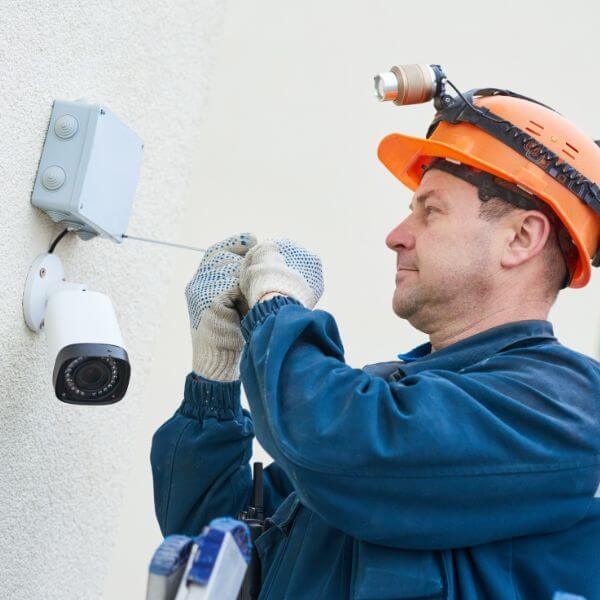 Home Security Guys completing home security camera installation in Sydney with wired CCTV setup on external wall.